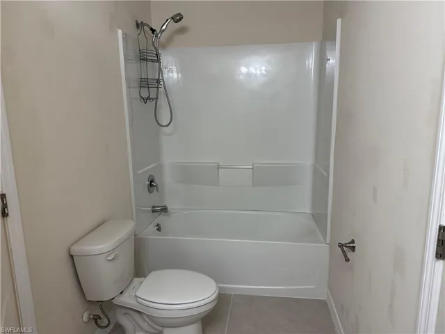 Full bathroom featuring tile patterned flooring and bathing tub / shower combination