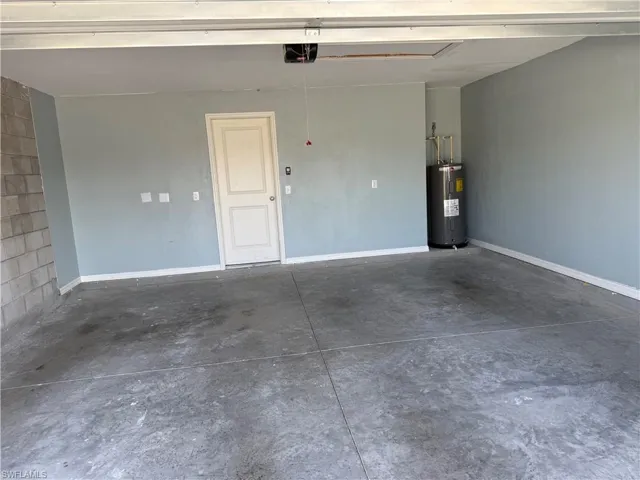 Garage with water heater and a garage door opener
