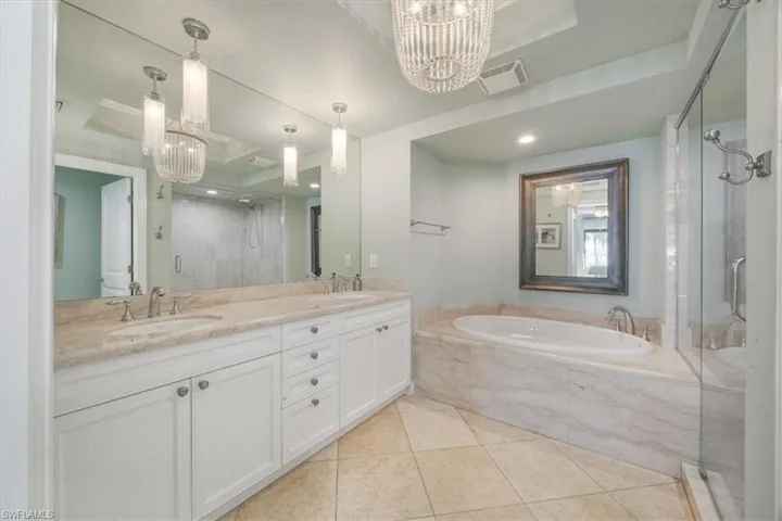 Primary bath with jacuzzi soaking tub and walk-in shower