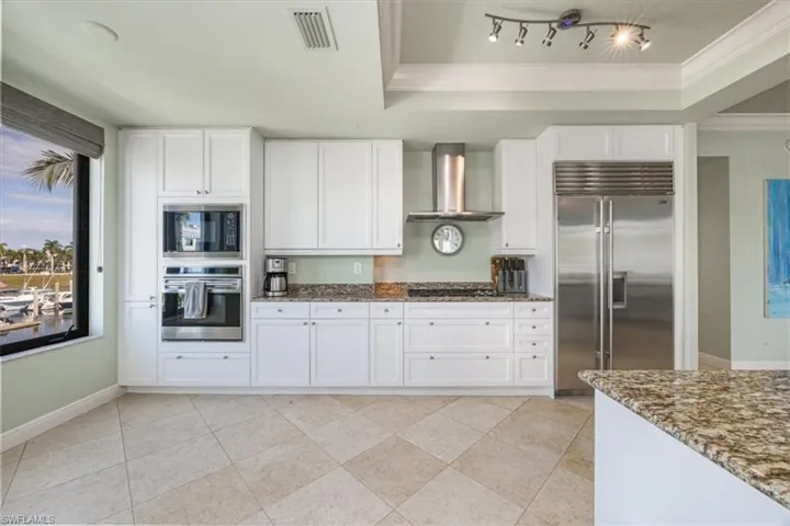 Kitchen featuring Wolf and Sub-Zero appliances and wine fridge