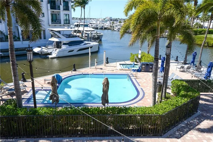 View of private pool with patio, spa, with Naples Bay and Marina views