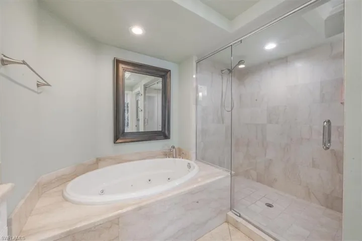 Primary bath with jacuzzi soaking tub and walk-in shower