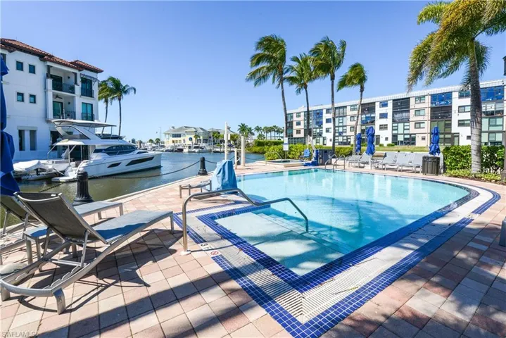 View of private pool with patio, spa, with Naples Bay and Marina views
