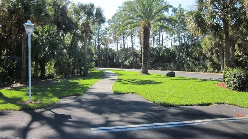 View of home's community with a lawn