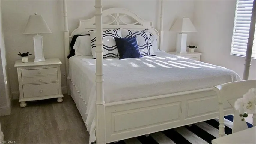 Bedroom with dark wood-type flooring