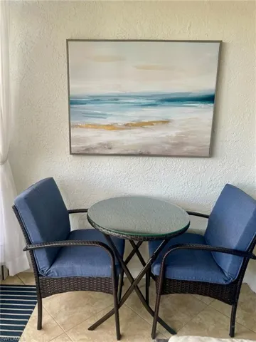 Dining area featuring a textured wall and tile patterned floors