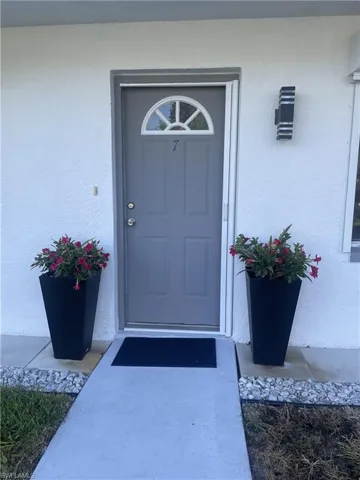 Doorway to property with stucco siding