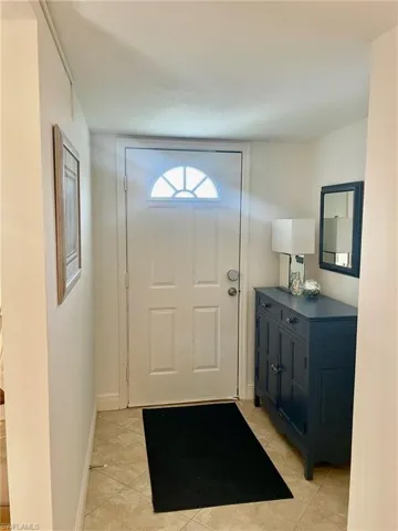 Doorway featuring tile patterned floors