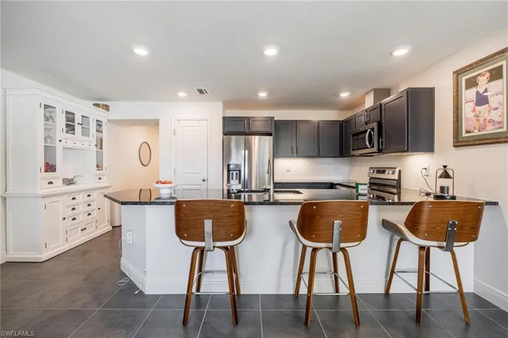 Kitchen with stainless steel appliances and breakfast bar