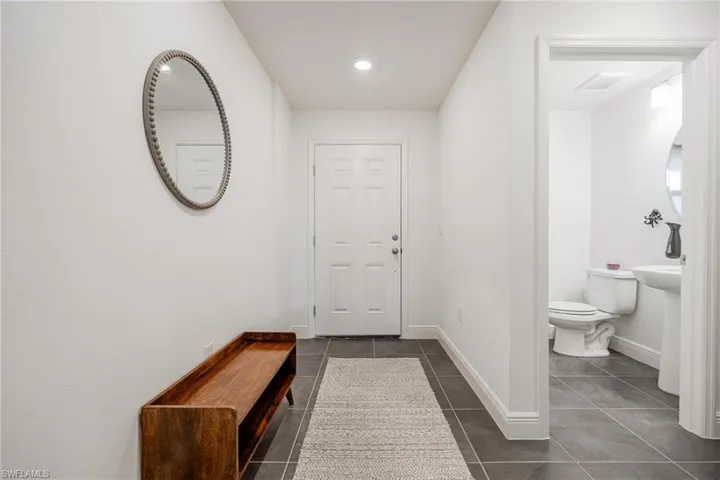 Entryway Foyer, with storage, guest bath, and access to garage