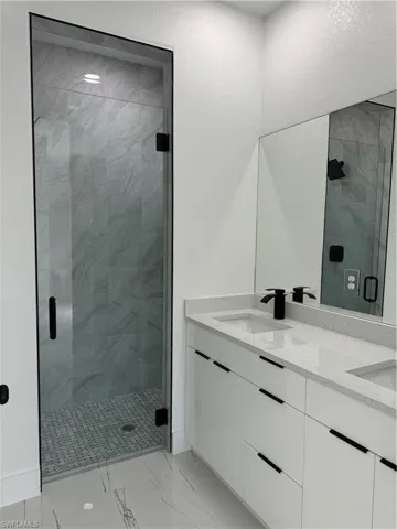 Bathroom with vanity and an enclosed shower
