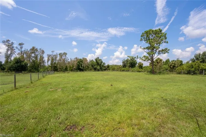 View of yard with a rural view