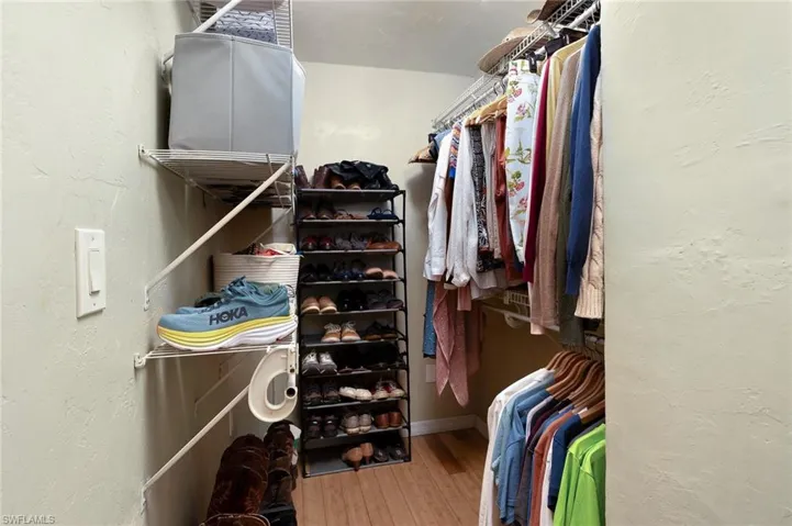 Spacious closet with hardwood / wood-style floors