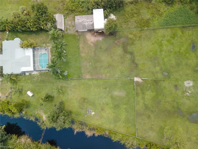 Birds eye view of property with a water view