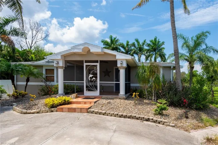 View of front of house with a sunroom and a patio