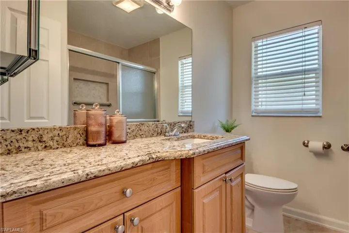 Bathroom with tile patterned floors, toilet, and vanity