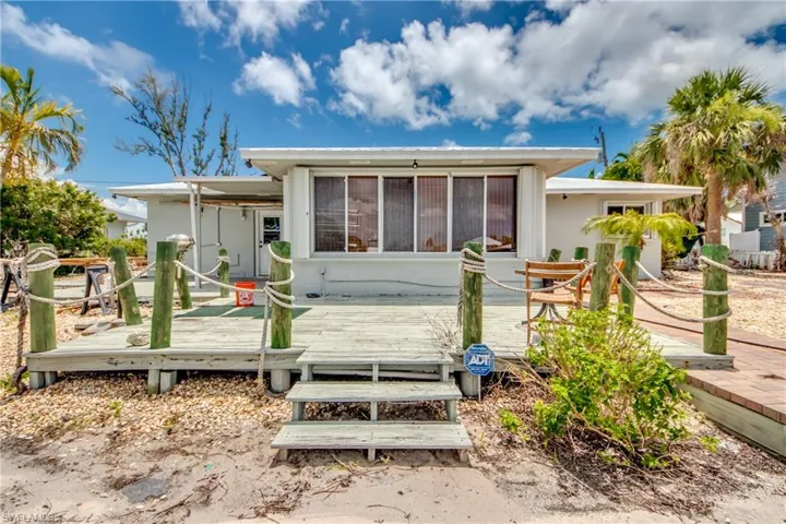 Back of property featuring a wooden deck