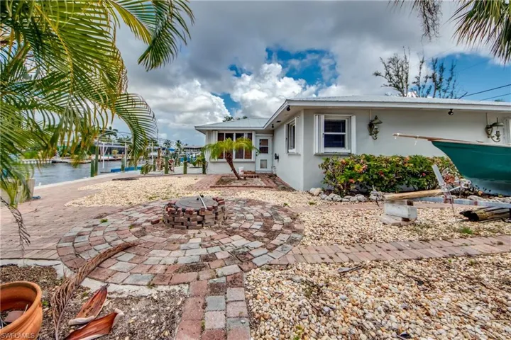 Back of house with a patio area and an outdoor fire pit