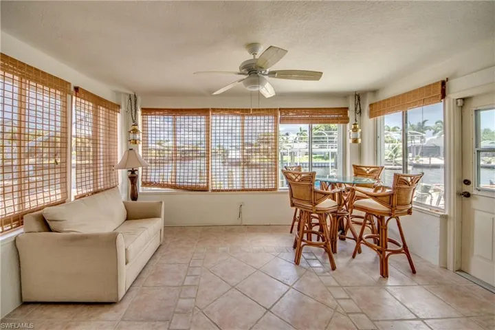 Sunroom featuring ceiling fan