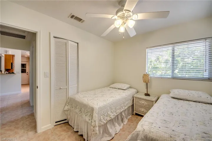 Tiled bedroom featuring a closet and ceiling fan