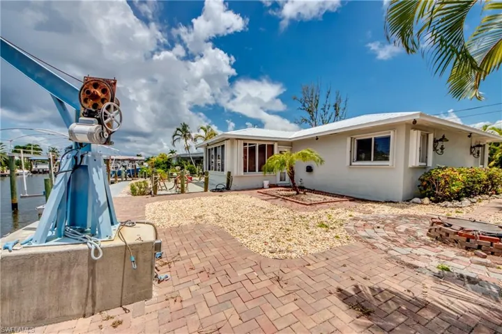 Back of property featuring a sunroom and a patio area