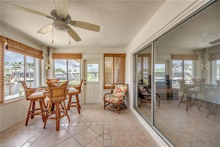 Sunroom / solarium featuring ceiling fan