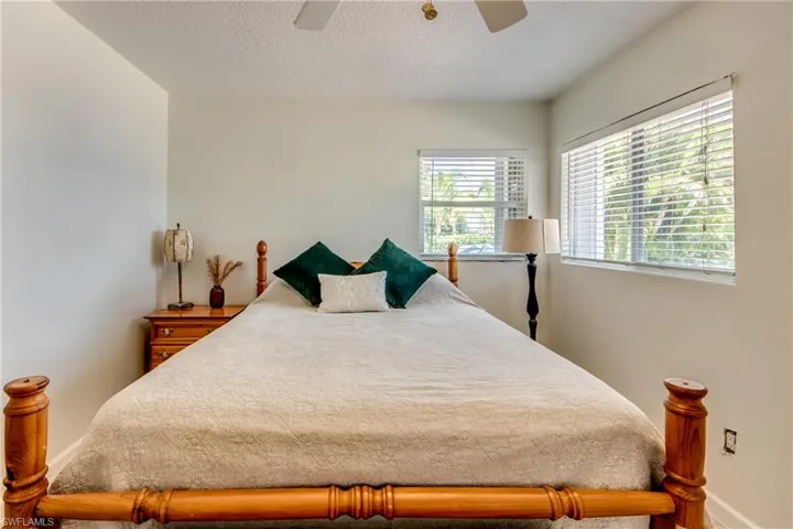 Bedroom with a textured ceiling and ceiling fan