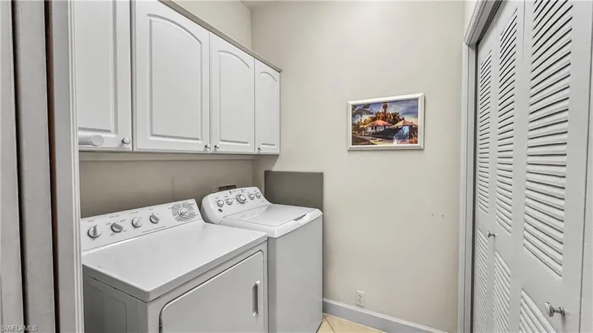 Laundry area featuring cabinets and washing machine and clothes dryer