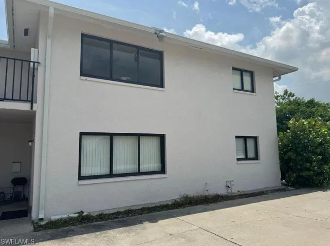 View of side of property featuring stucco siding