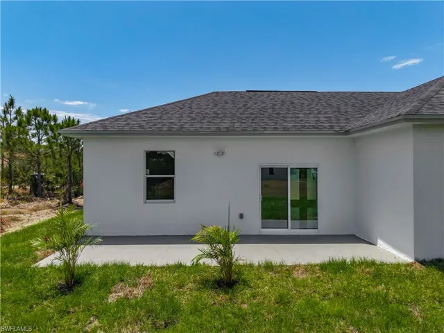 Back of property with roof with shingles, a patio area, and stucco siding