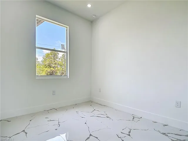 Unfurnished room featuring baseboards and recessed lighting