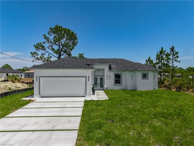 Single story home featuring french doors, roof with shingles, a front lawn, and stucco siding