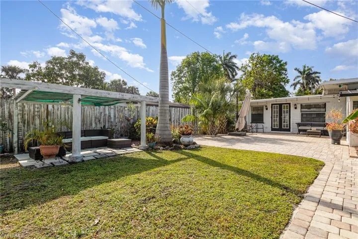 View of yard featuring french doors, a fenced backyard, and a patio area