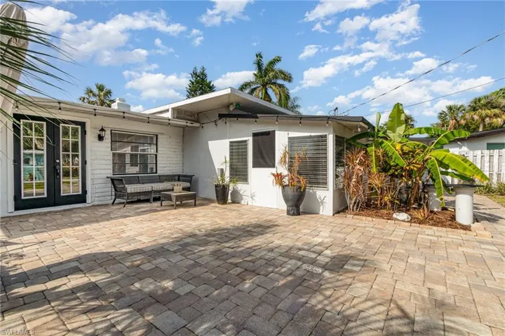 View of patio with an outdoor living space and fence