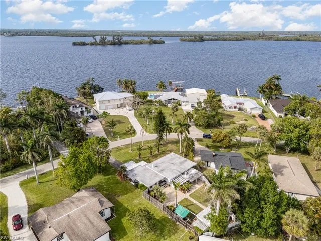 Birds eye view of property with a water view and a residential view