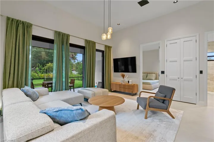 Living area with recessed lighting and a chandelier
