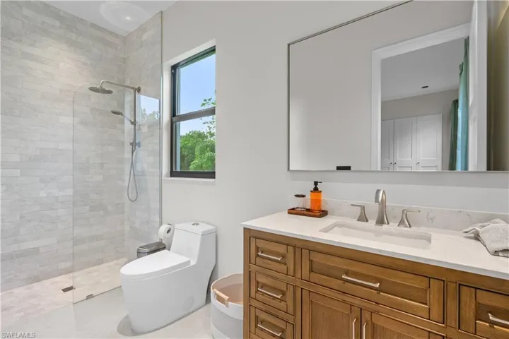 Bathroom with walk in shower and vanity