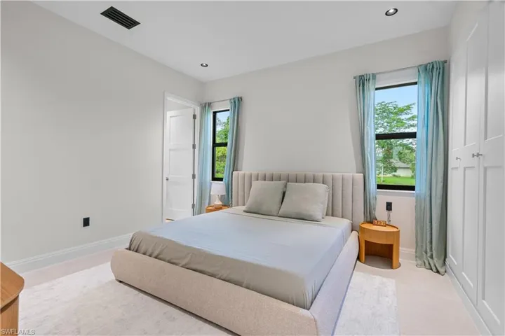 Carpeted bedroom with baseboards and recessed lighting