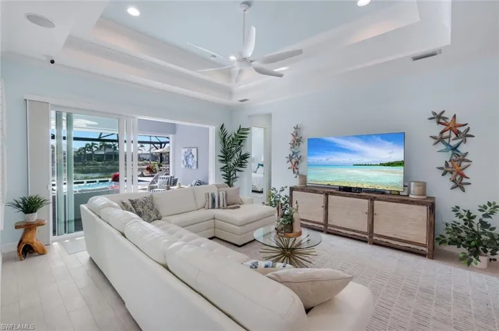 Living area featuring a ceiling fan, recessed lighting, a sunroom, and light wood finished floors