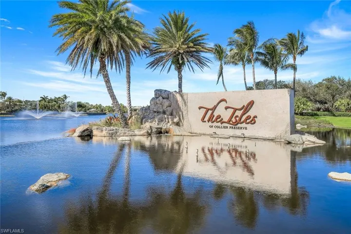 Community / neighborhood sign featuring a water view