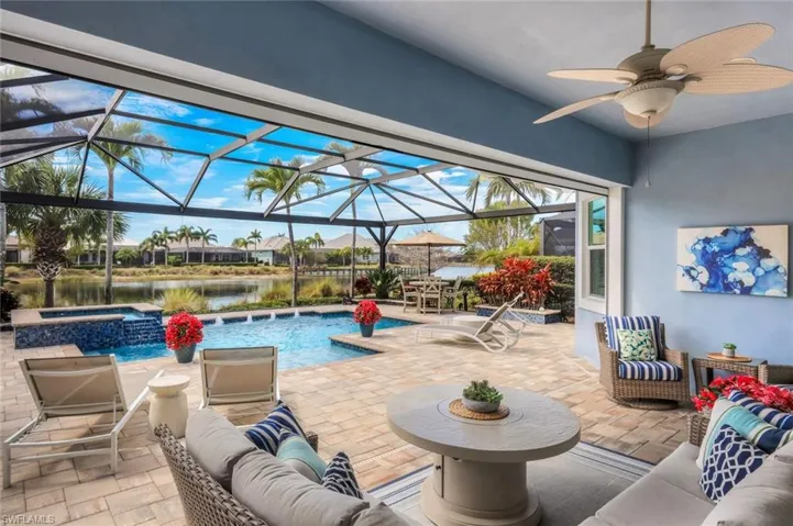 Integrated pool / spa featuring a patio area, glass enclosure, a sunroom, a water view, and a residential view