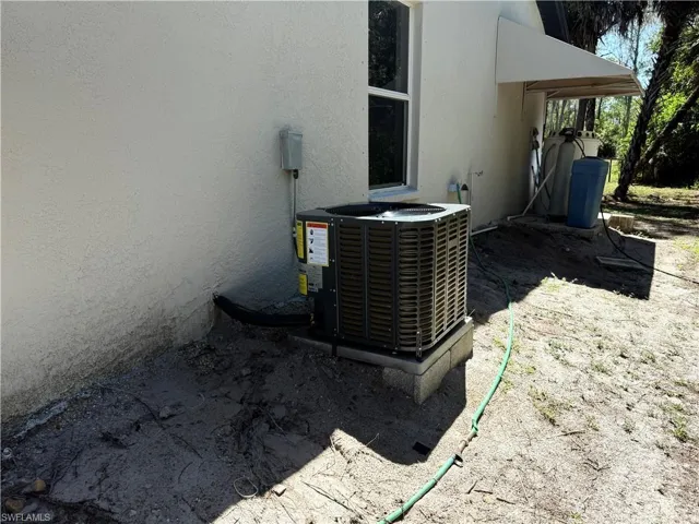 Exterior details featuring central air condition unit and stucco siding
