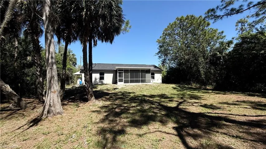 View of yard with a sunroom