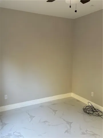 Unfurnished room featuring ceiling fan