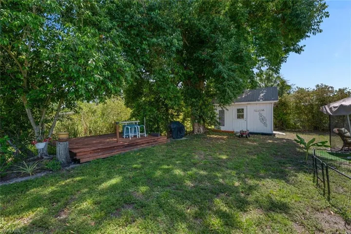 View of yard featuring a deck and an outdoor structure