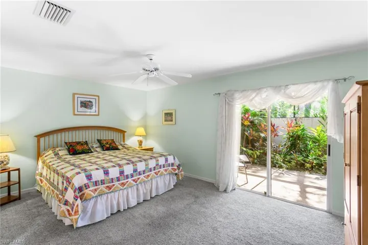 The first-floor primary suite has room for a king bedroom set plus sitting area, and has direct access to the screened lanai.