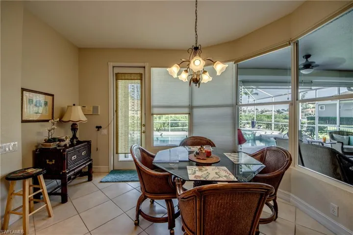 Dining space featuring light tile patterned floors, a ceiling fan, and hanging lights