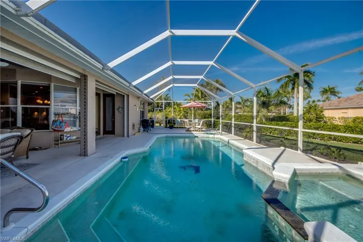 Integrated pool / spa featuring a lanai and a sunroom