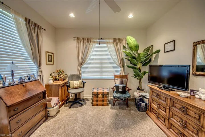Living area with ceiling fan, carpet, and recessed lighting