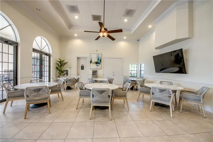 Dining room with crown molding, ceiling fan, recessed lighting, light tile patterned flooring, and french doors